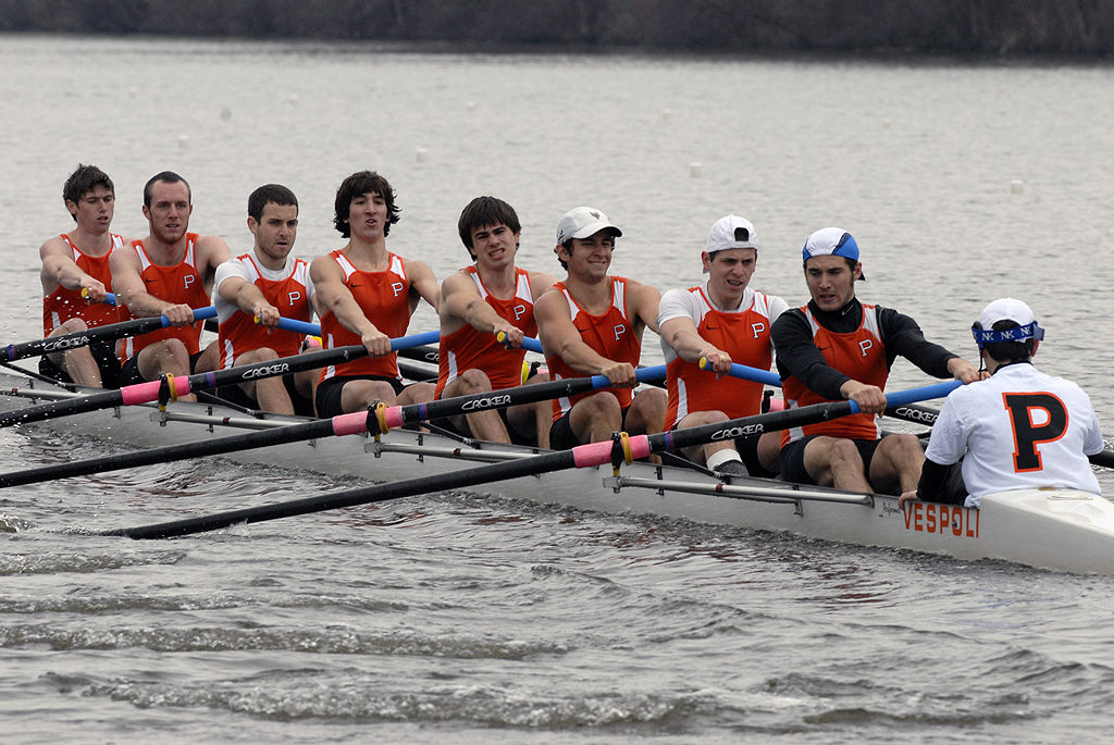 George Watsky et al. rowing a boat in the water