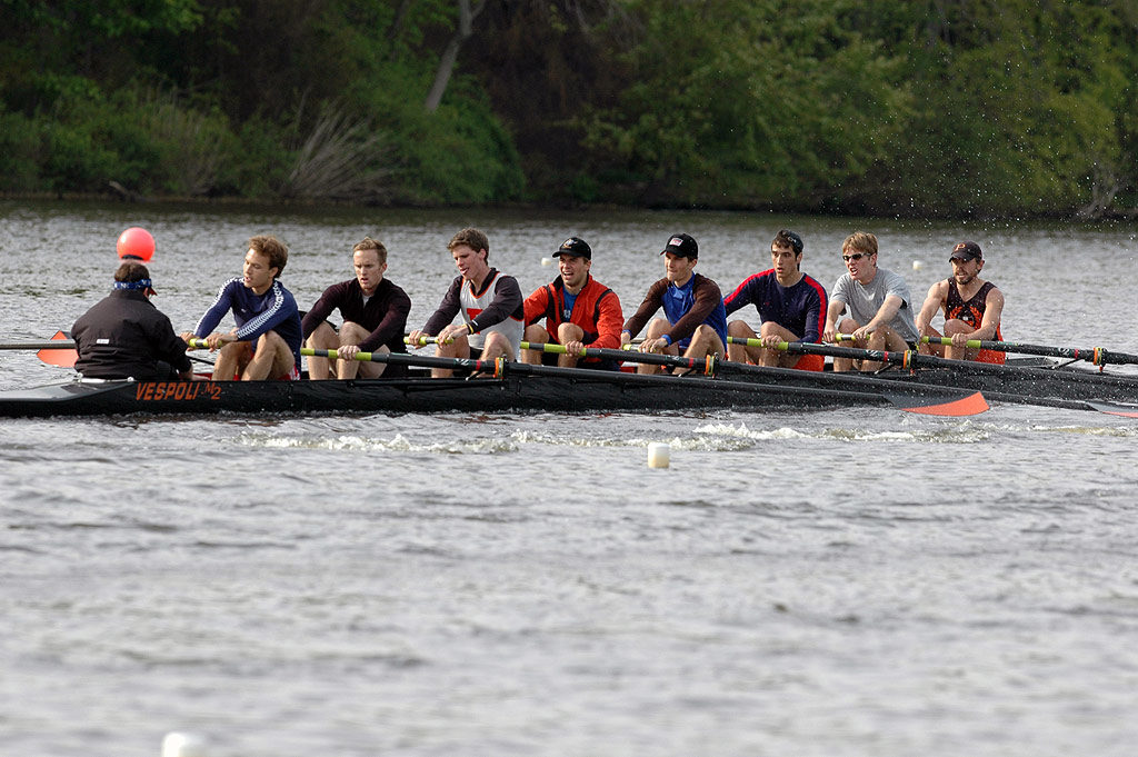 A group of people rowing a boat in the water