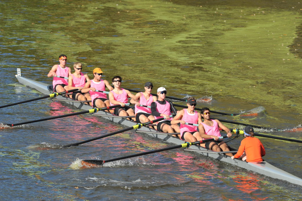 A group of people rowing a boat in the water