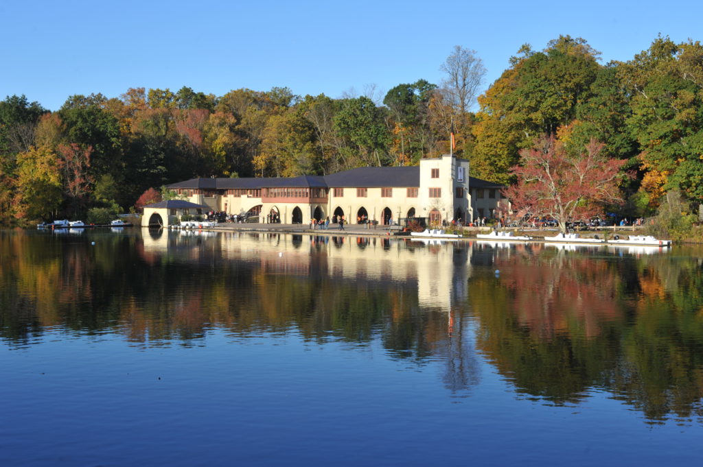 A bridge over a body of water surrounded by trees