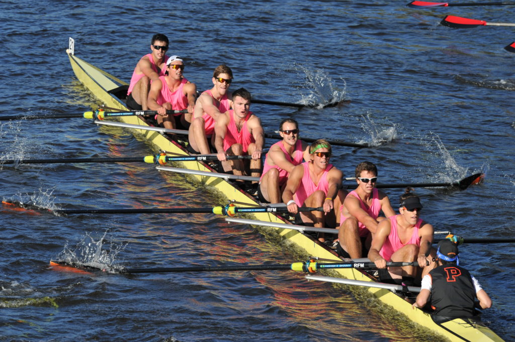 A group of people rowing a boat in the water