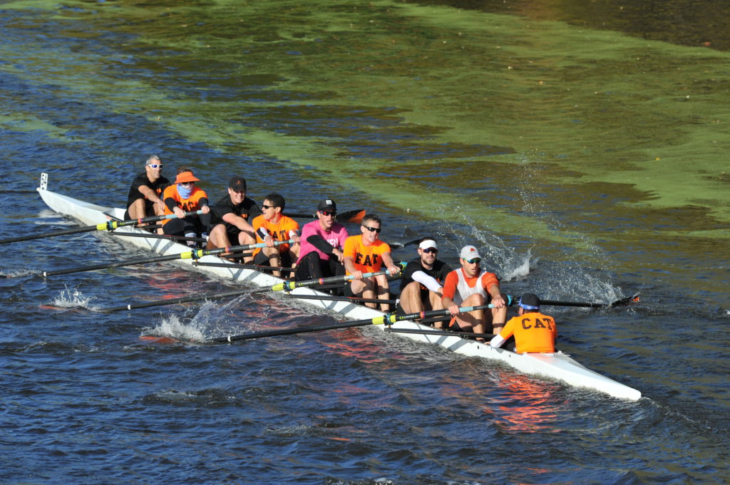 A group of people rowing a boat in the water