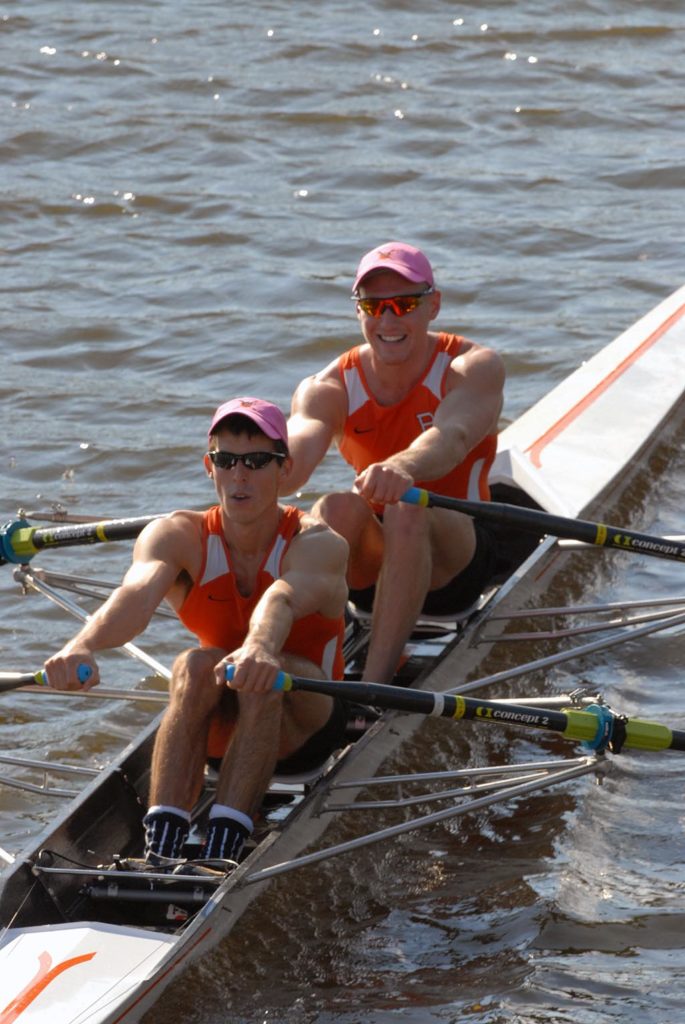 A group of people rowing a boat in the water