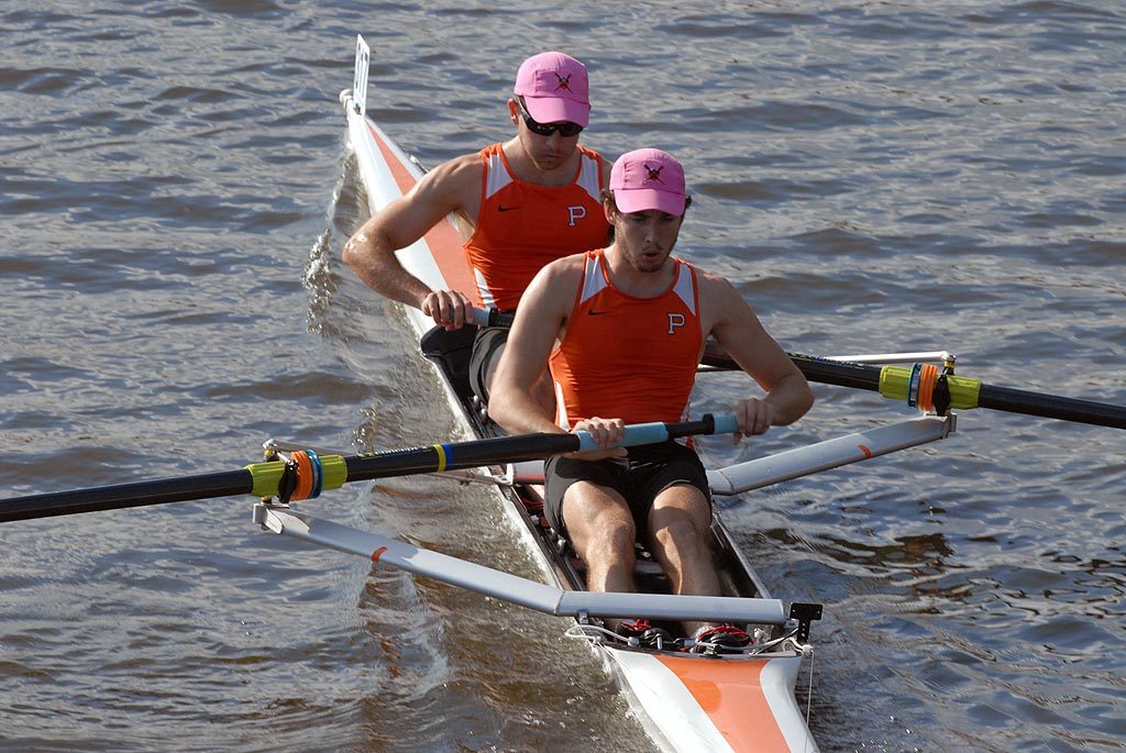 A man rowing a boat in a body of water