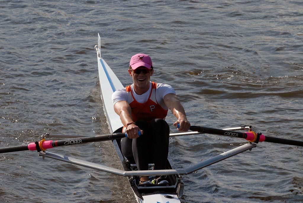 A man rowing a boat in a body of water