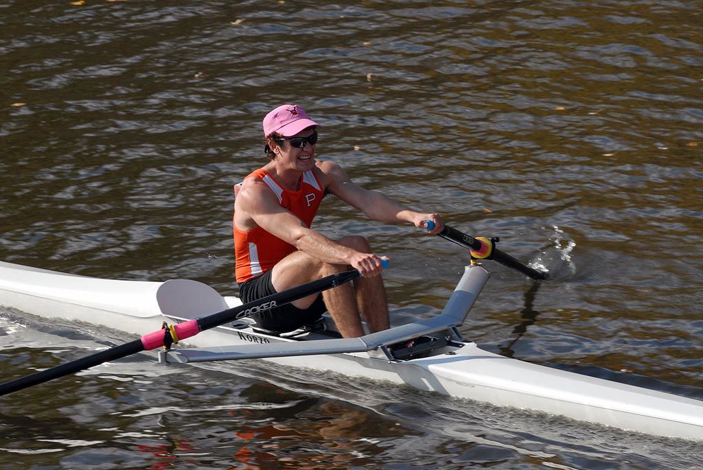 A man rowing a boat in a body of water