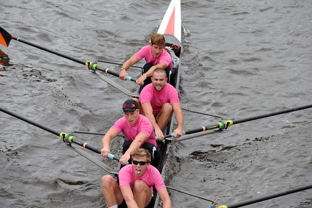 A group of people rowing a boat in the water