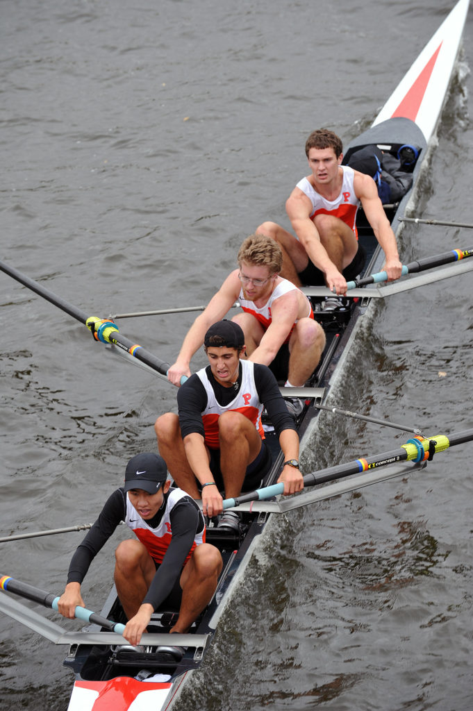 A group of people rowing a boat in the water