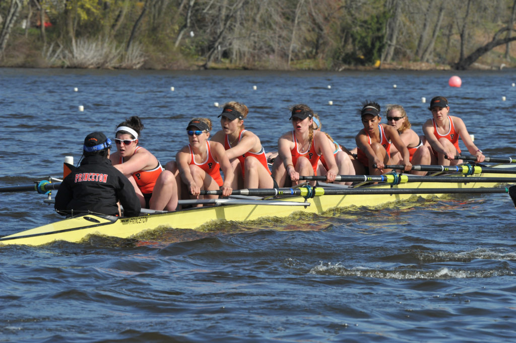 A group of people rowing a boat in the water