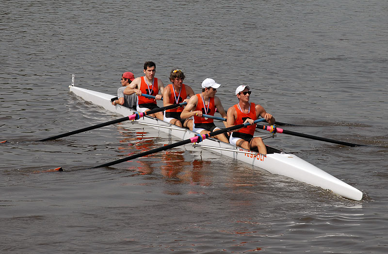 A group of people rowing a boat in the water