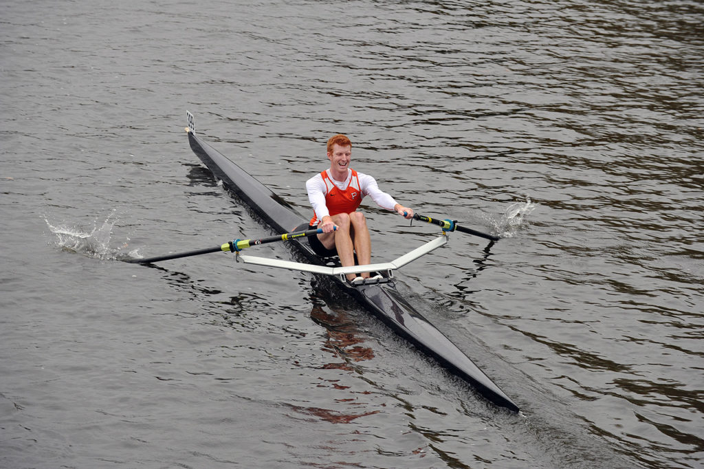 A man rowing a boat in the water