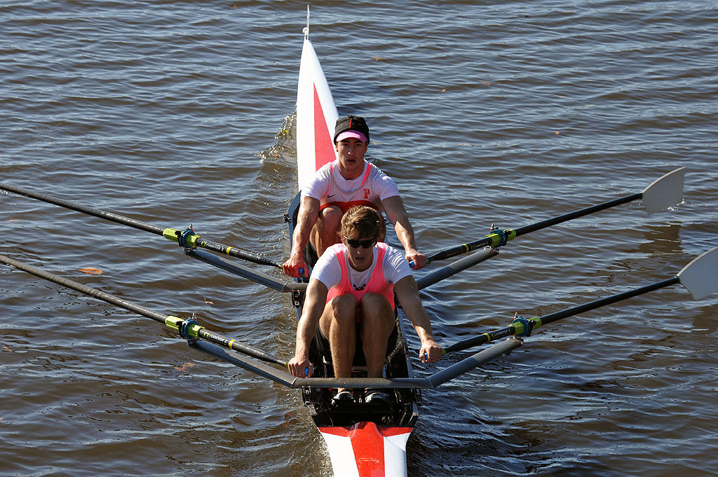 A person rowing a boat in a body of water