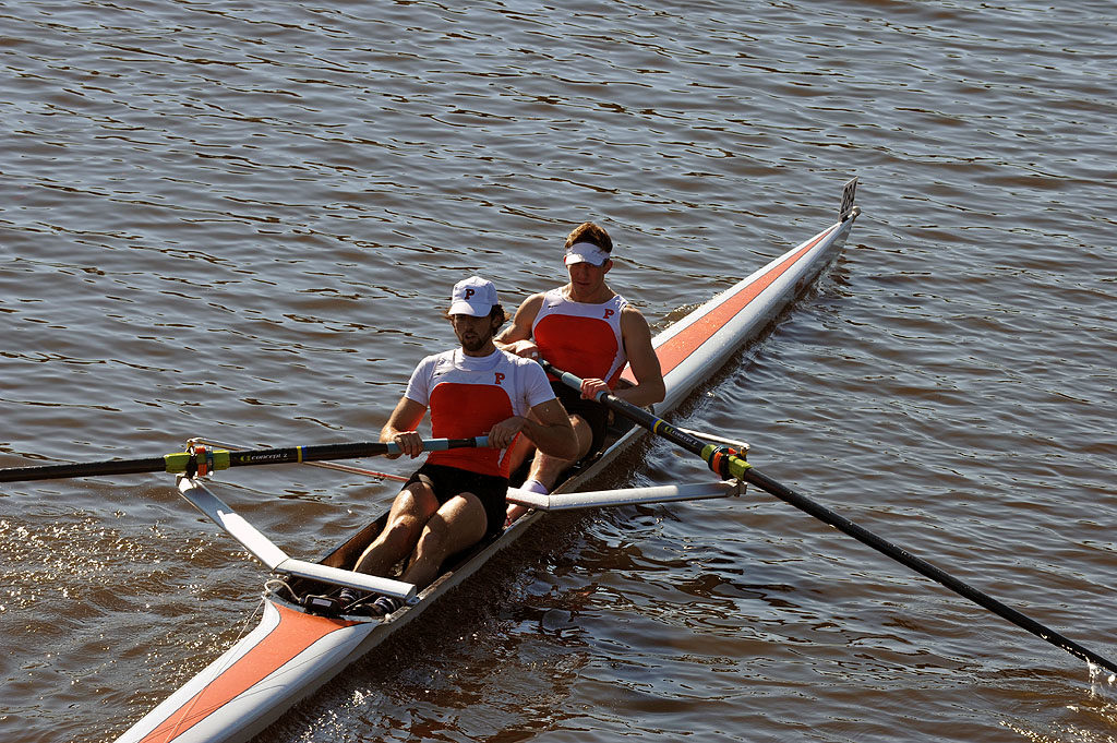 A man rowing a boat in a body of water