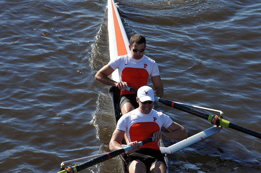 A man rowing a boat in a body of water