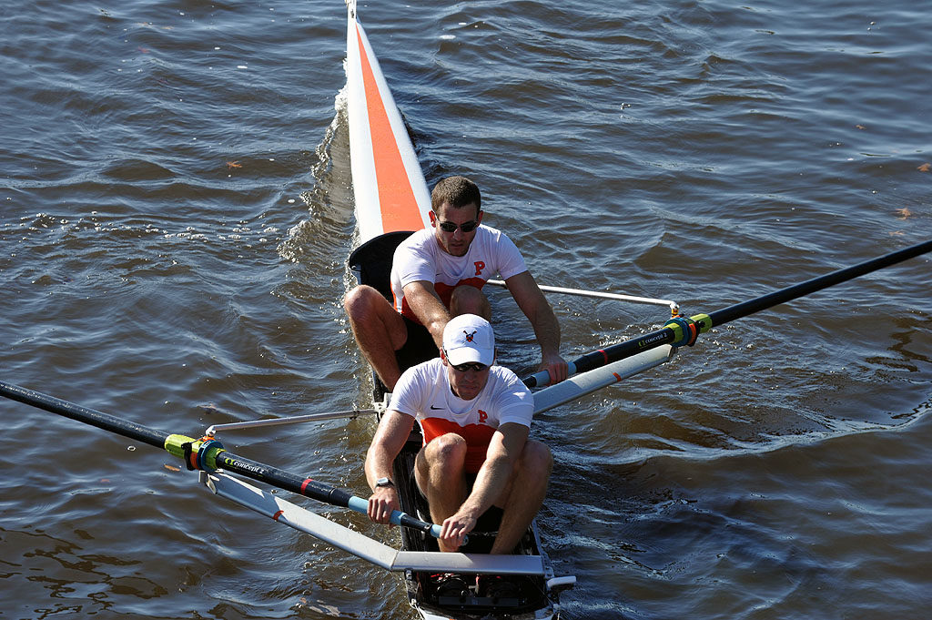 A man rowing a boat in a body of water