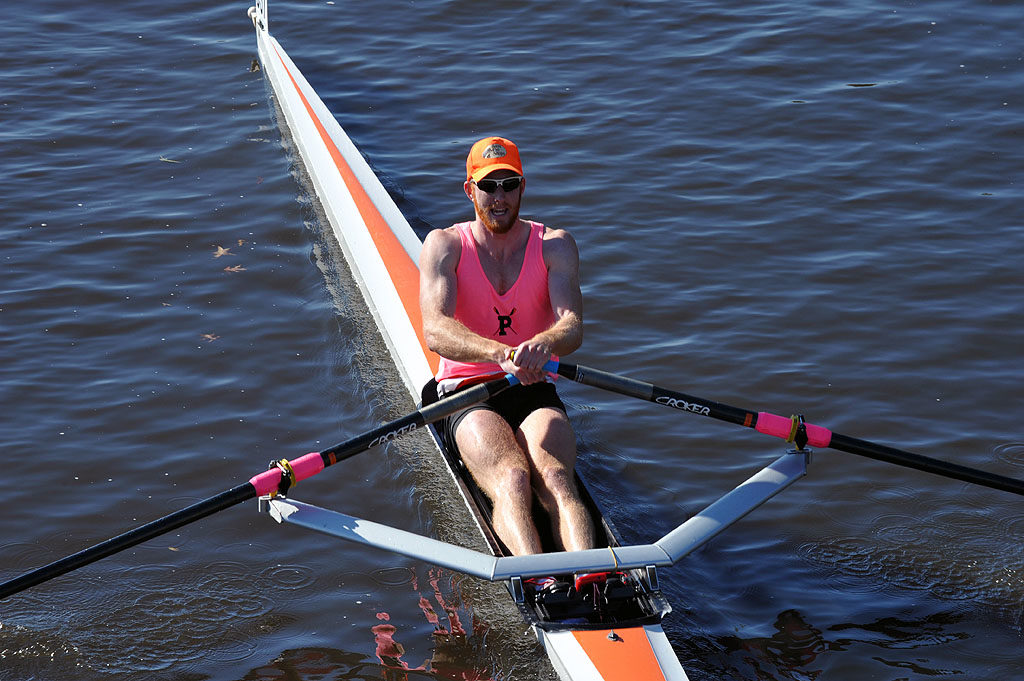 A man rowing a boat in a body of water