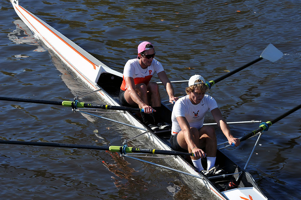 A man rowing a boat in a body of water