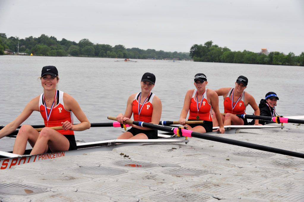 A group of people rowing a boat in the water