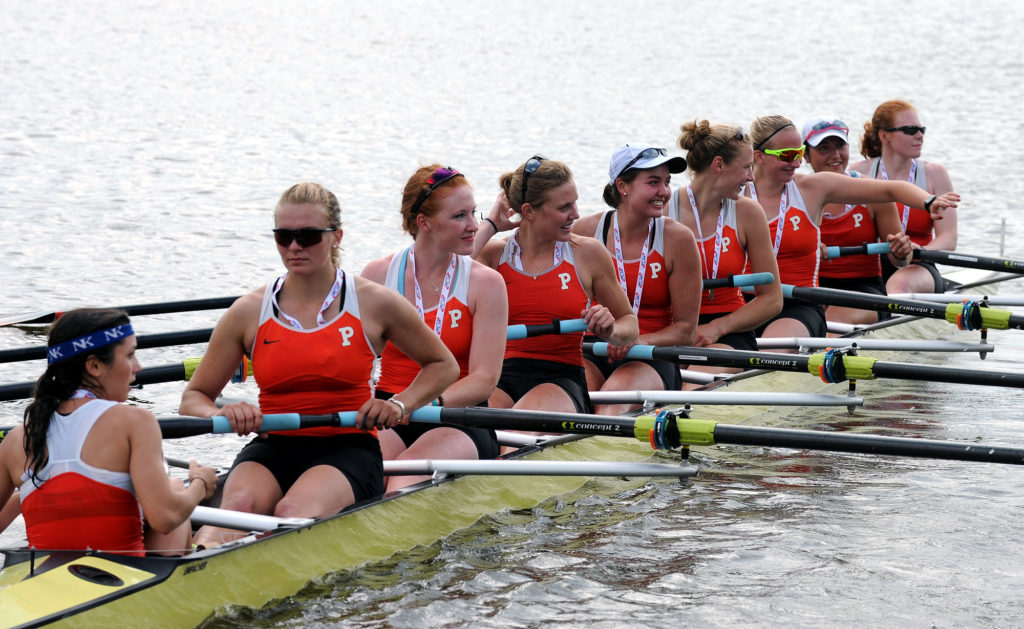 A group of people rowing a boat in the water