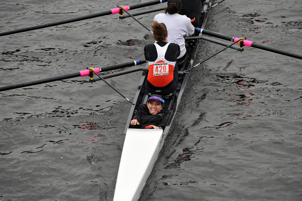 A group of people rowing a boat in the water