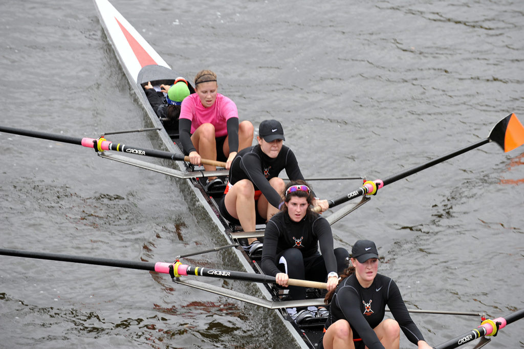 A group of people rowing a boat in the water