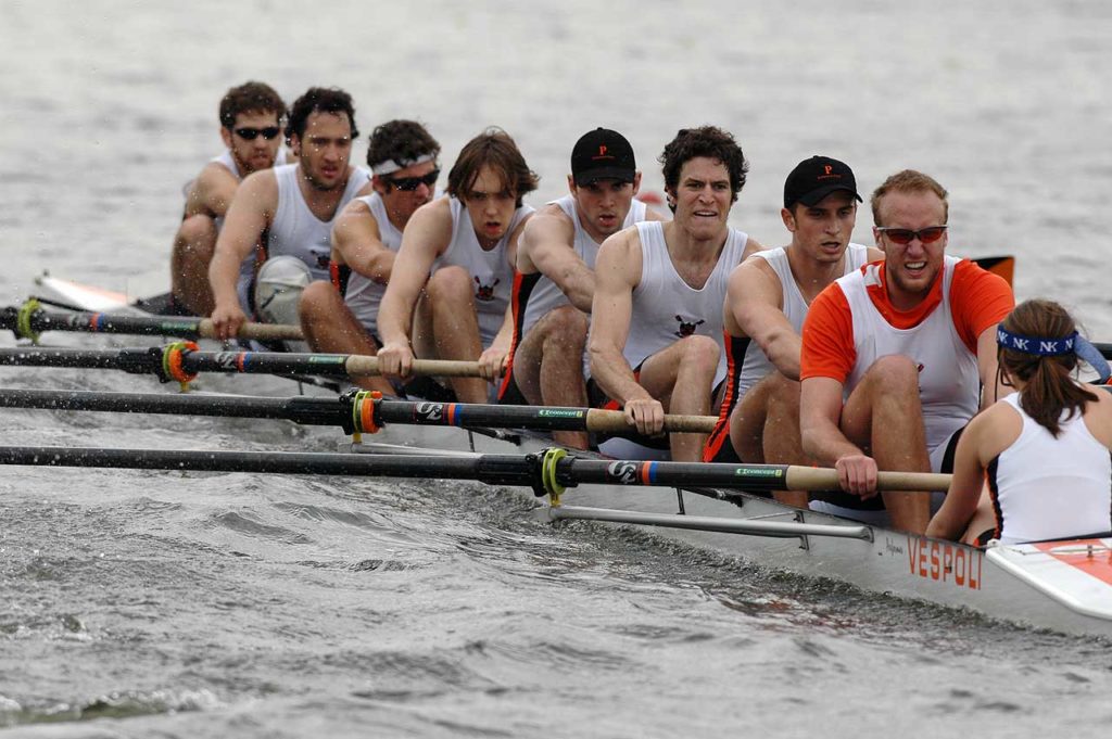 Diarmaid Murtagh et al. rowing a boat in the water