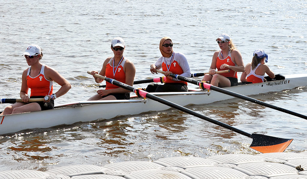 A group of people rowing a boat in the water