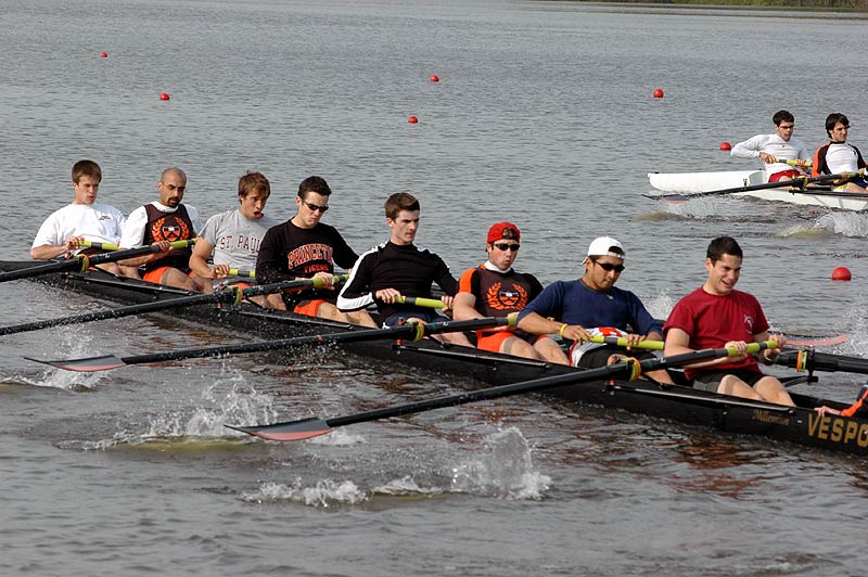 A group of people rowing a boat in the water