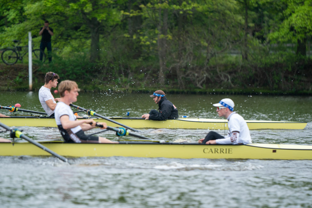 A group of people rowing a boat in the water