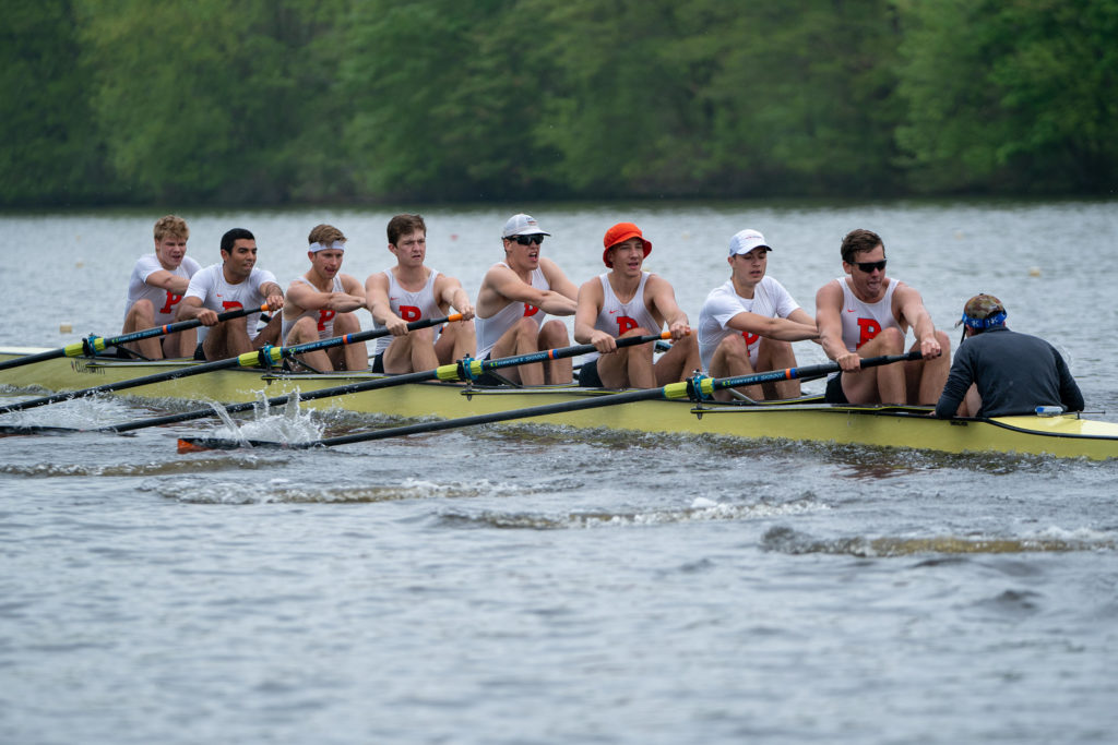 A group of people rowing a boat in the water