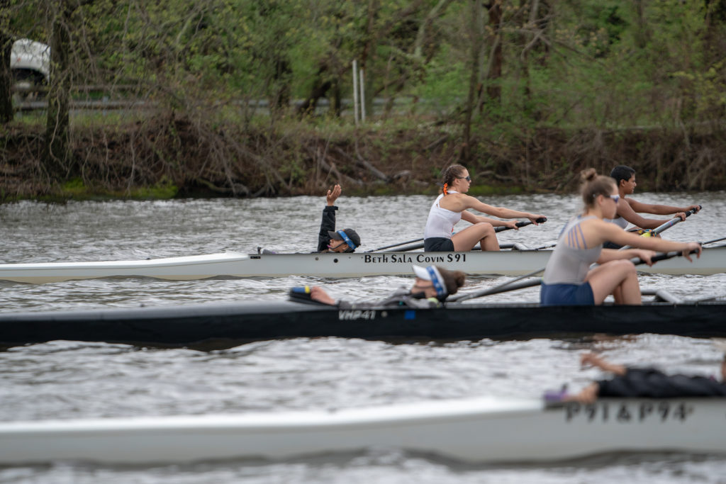 A group of people rowing a boat in the water