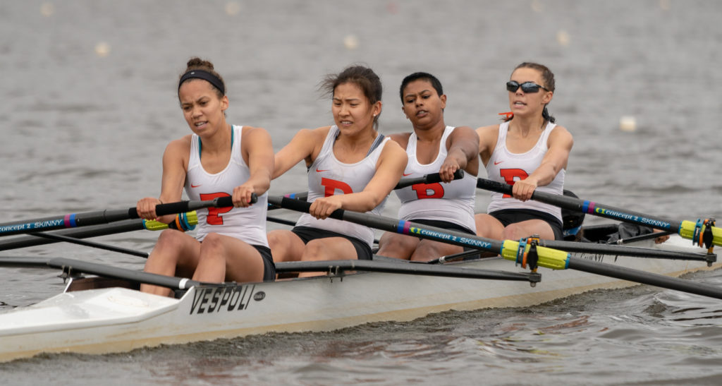 Latorial Faison et al. rowing a boat in the water