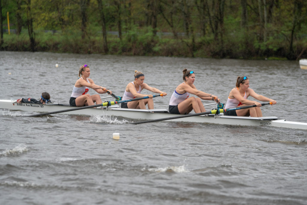 A group of people rowing a boat in the water