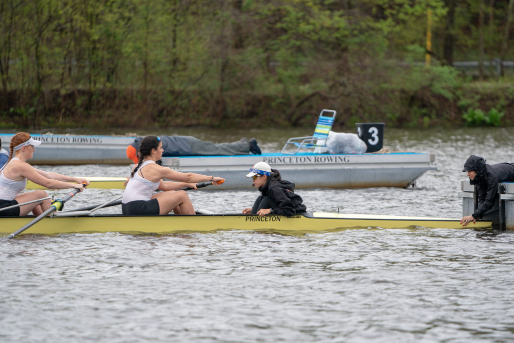 A group of people rowing a boat in the water