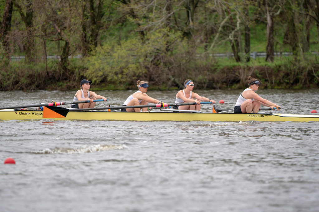 A group of people rowing a boat in the water