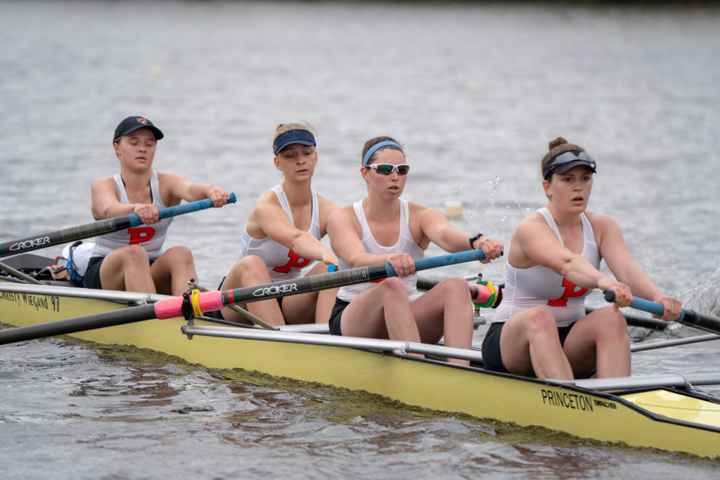 A group of people rowing a boat in the water