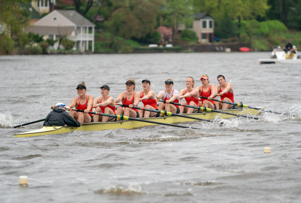 A group of people rowing a boat in the water