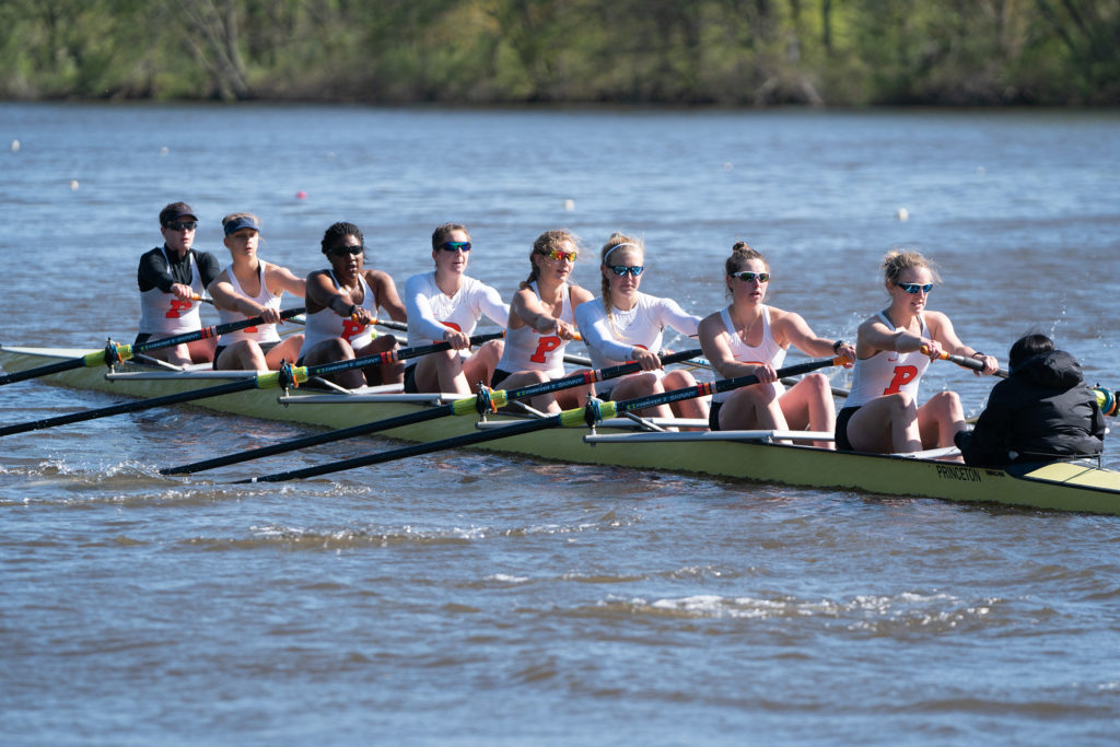 A group of people rowing a boat in the water