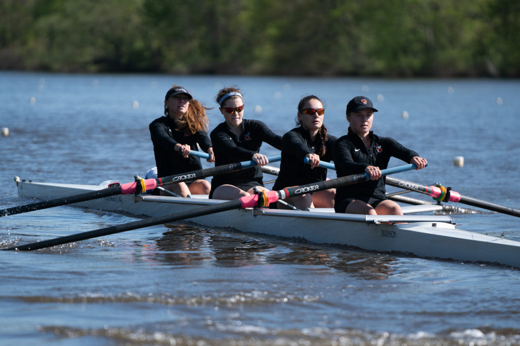 A group of people rowing a boat in the water