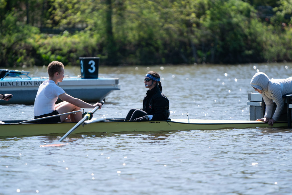 A group of people rowing a boat in the water