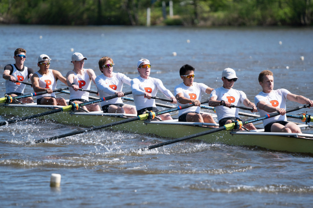 A group of people rowing a boat in the water