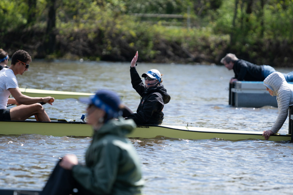 A group of people rowing a boat in the water