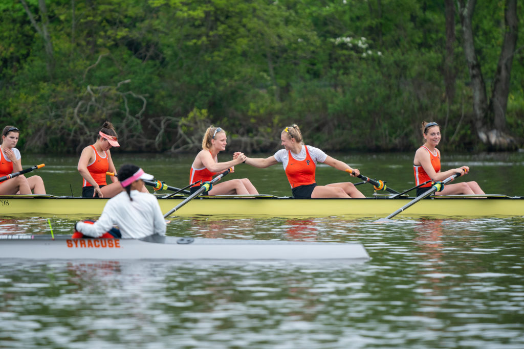 A group of people rowing a boat in the water