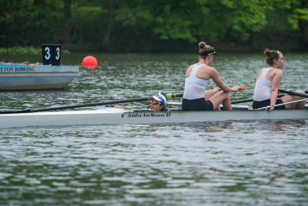 A group of people rowing a boat in the water