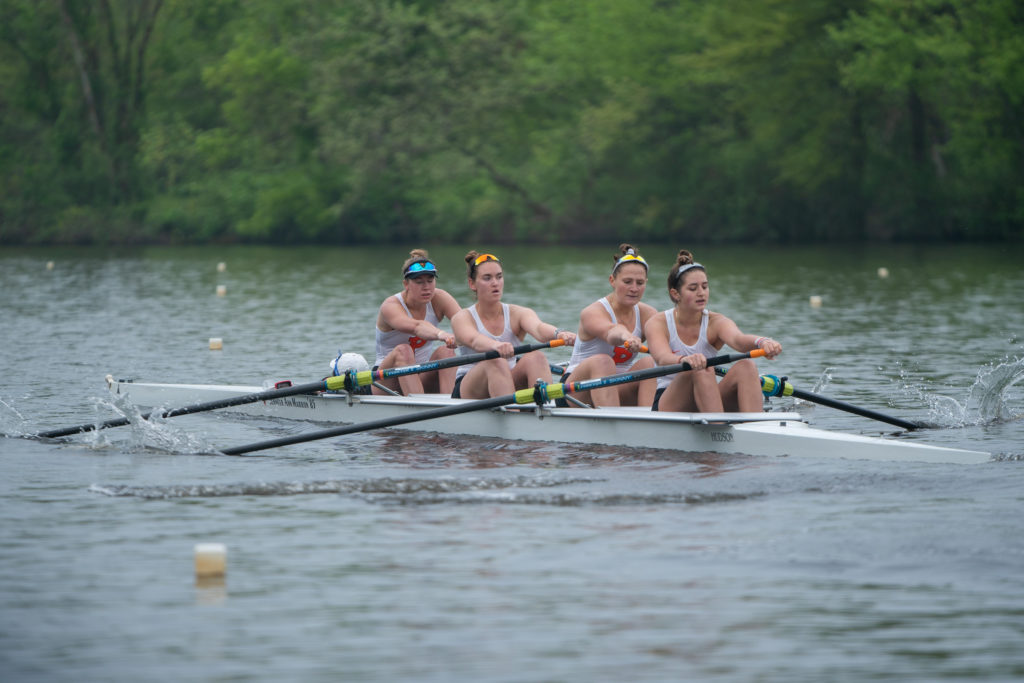 A group of people rowing a boat in the water