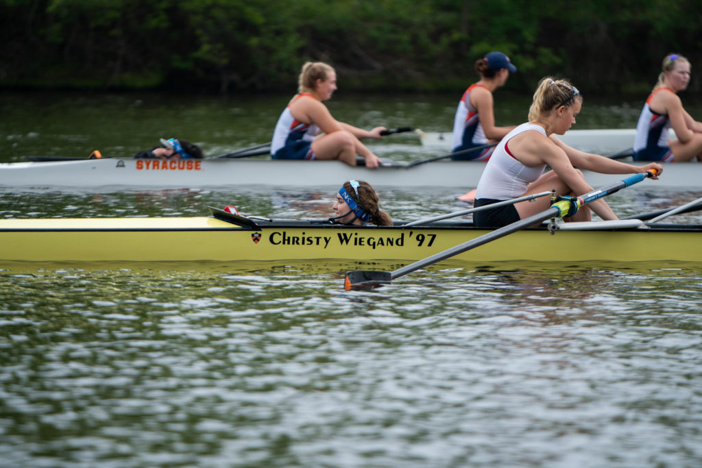 A group of people rowing a boat in the water