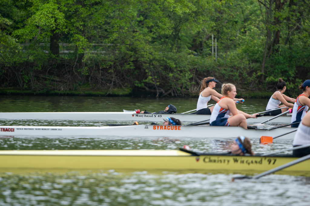 A group of people rowing a boat in the water