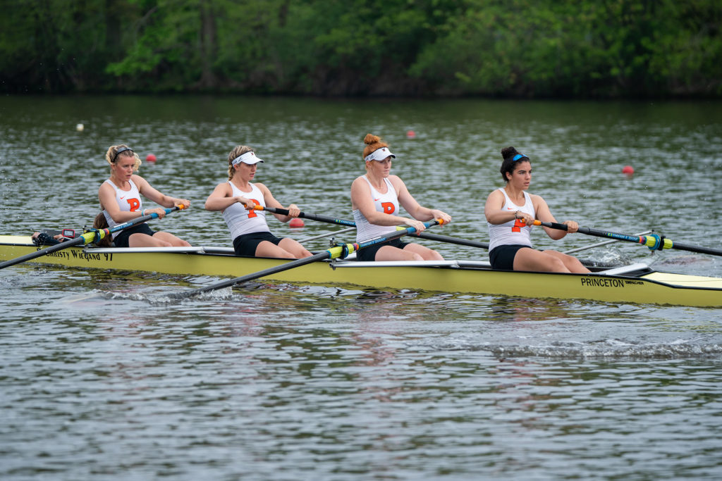 A group of people rowing a boat in the water