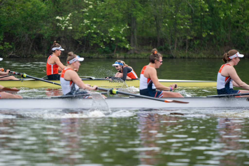 A group of people rowing a boat in the water