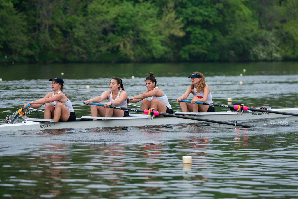 A group of people rowing a boat in the water